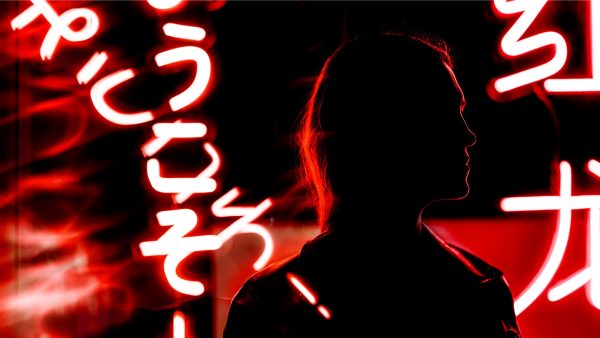 Think Report cover image: profile in silhouette with surrounding bright red lights