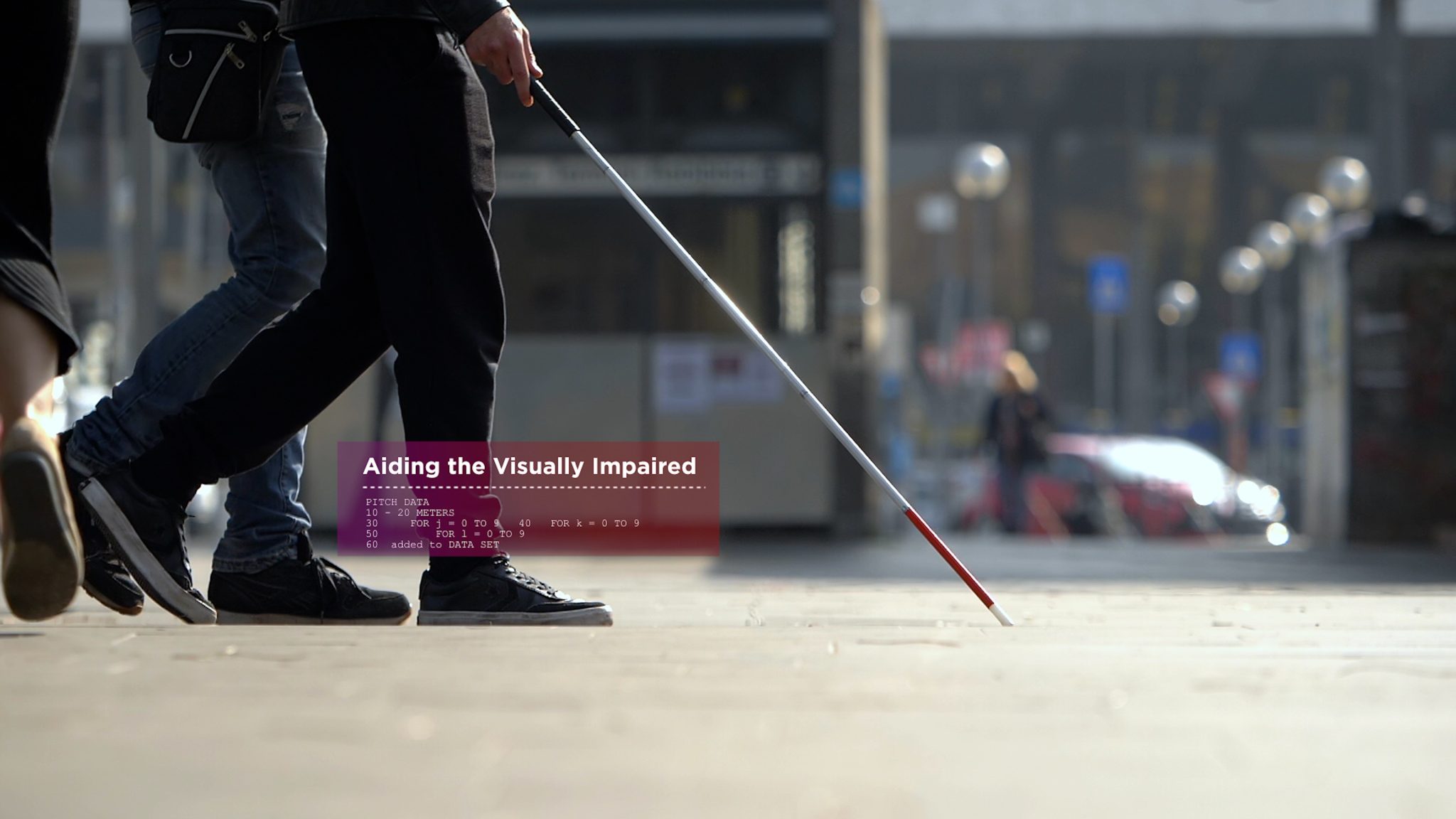 Low shot of someone using a cane to walk on a city sidewalk