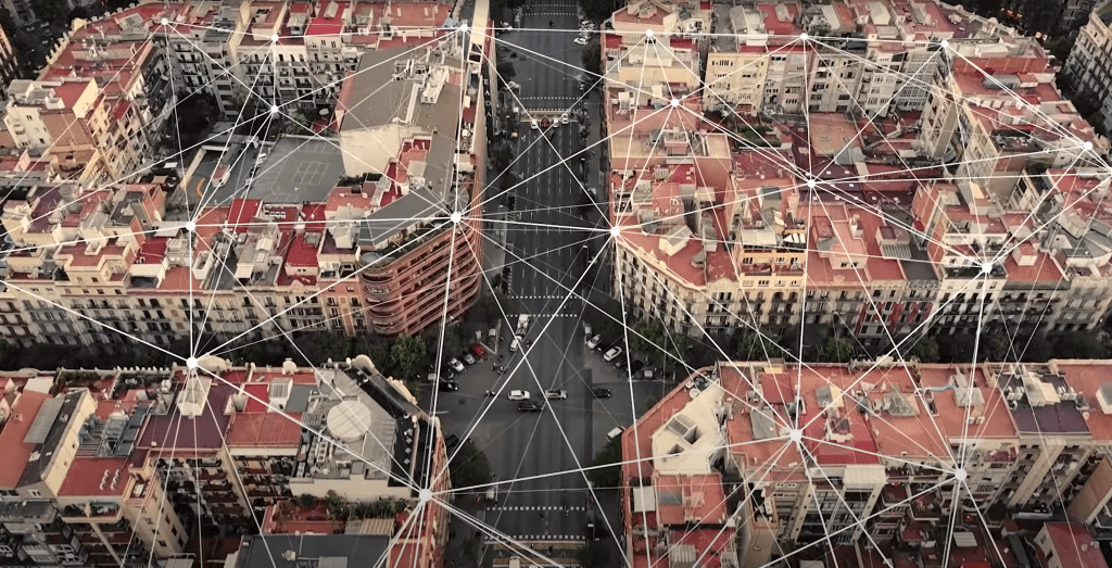 Arial view of Barcelona city overlaid with graphic lines representing connectivity across the city