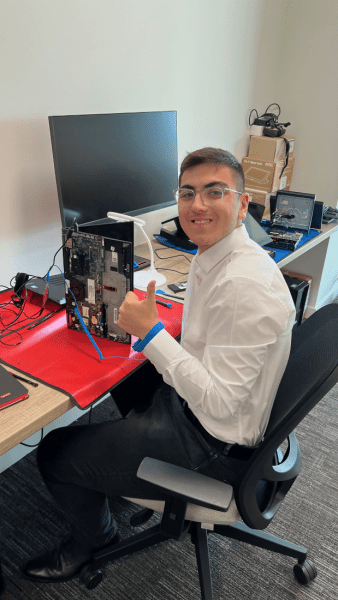 Ahmet student at Coxlease School working on a Lenovo product during his apprenticeship at Lenovo