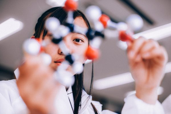 brand image - Person looking through a 3D model of a molecule