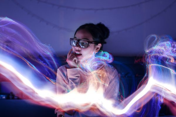 brand image - swirls of bright light around a woman wearing glasses