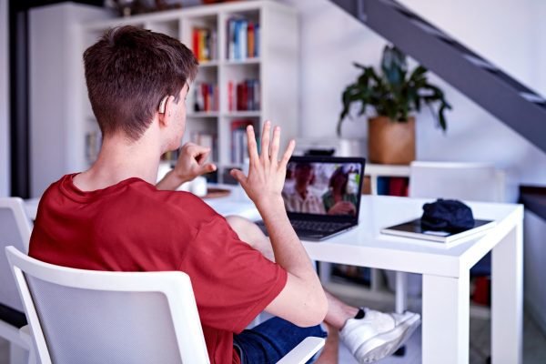 brand image - Person using sign-language to communicate with people on a Lenovo laptop
