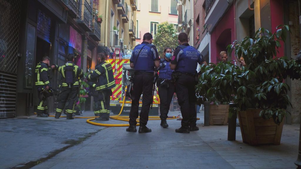 Emergency workers in a city alley