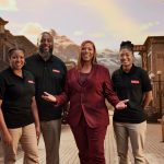 Queen Latifah with the Lenovo Evolve Small team standing on a small-town main street with a mountain in the distance.