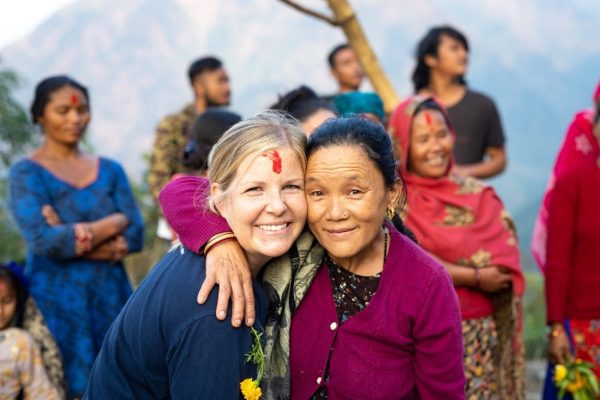 Courtney Mattar, Director of Partnerships (L) embraces Tulumaya Gurung (R), community member of Katheswora, Nepal - a village receiving support from Wine To Water.