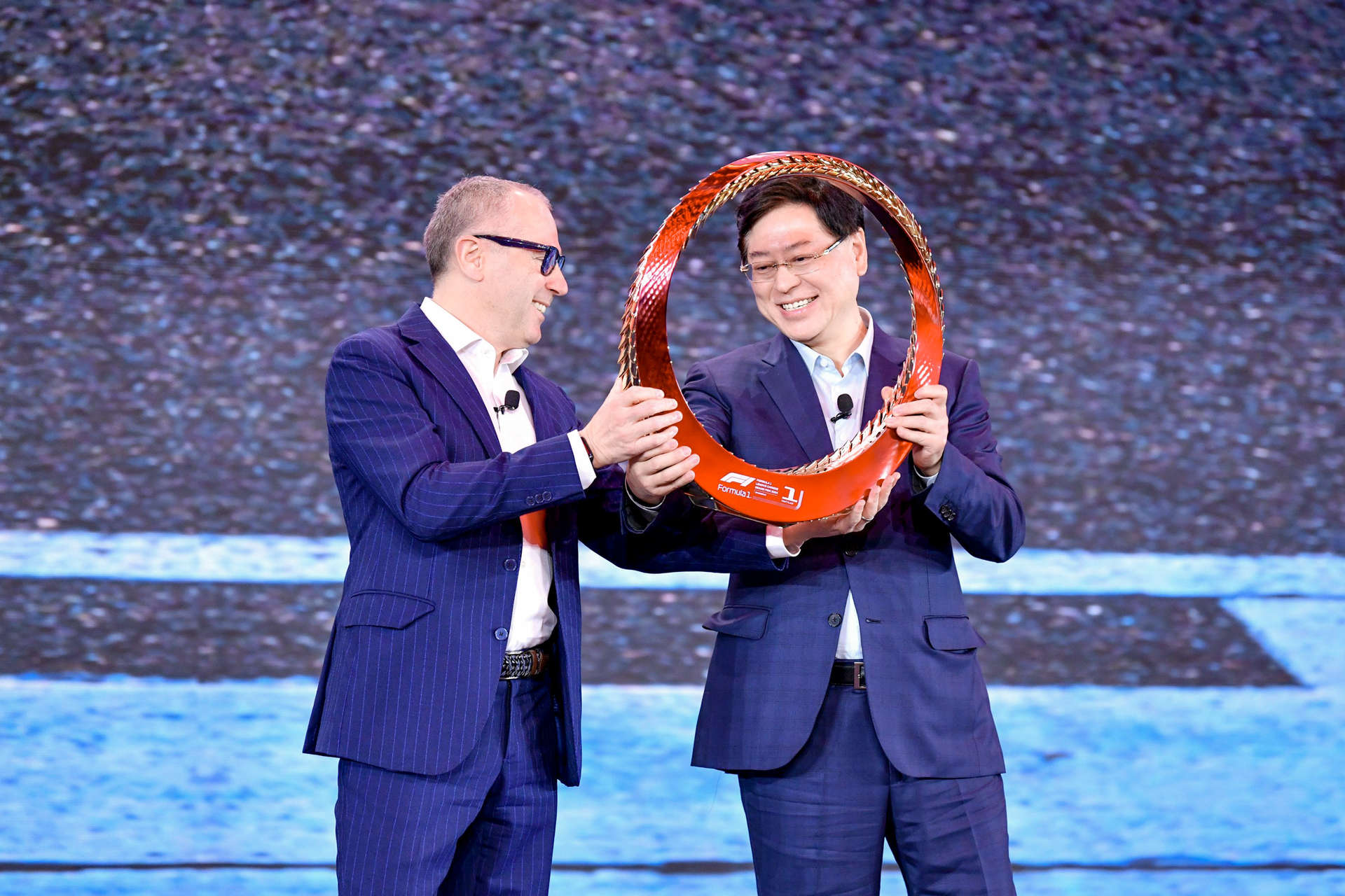 Yuanqing Yang and Formula One CEO Stefano Domenicali on stage at Tech World Shanghai