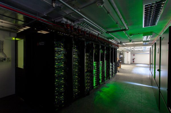 dark datacentre with green lighting and server racks