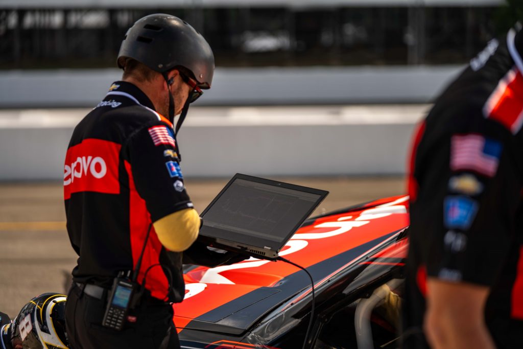 Pit crew member using Lenovo laptop.