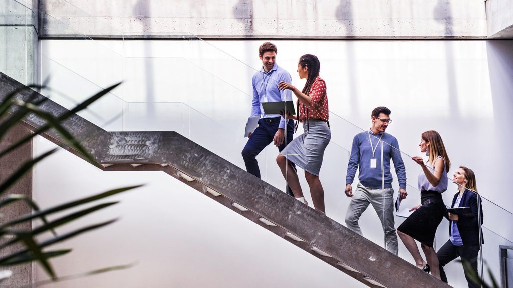 Brand image - Colleagues talking on a staircase.