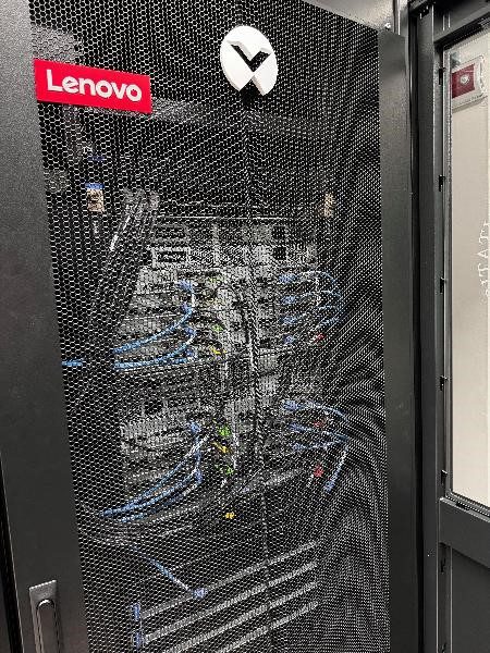 Lenovo server through cabinet door, wires visible