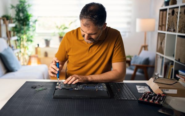 Person repairing a ThinkPad laptop