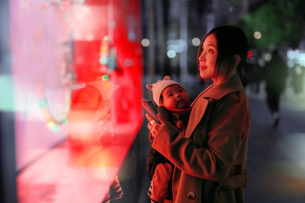 Brand image - Woman holding baby while window shopping