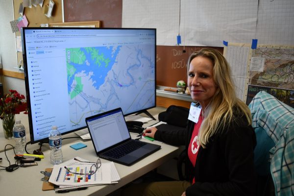 Western NC responder - woman at computer with map on an external monitor
