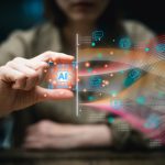 Person holding an AI chip icon with digital tech symbols and colorful data streams.