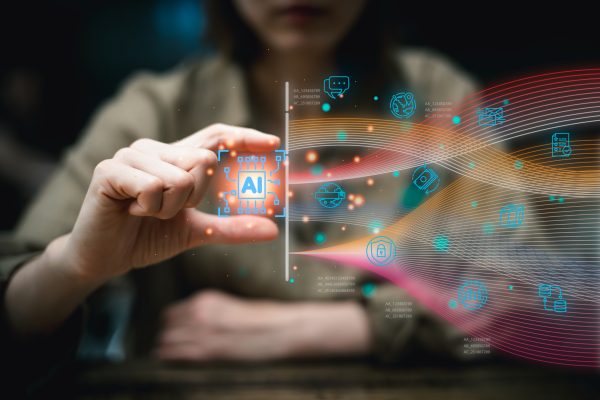 Person holding an AI chip icon with digital tech symbols and colorful data streams.